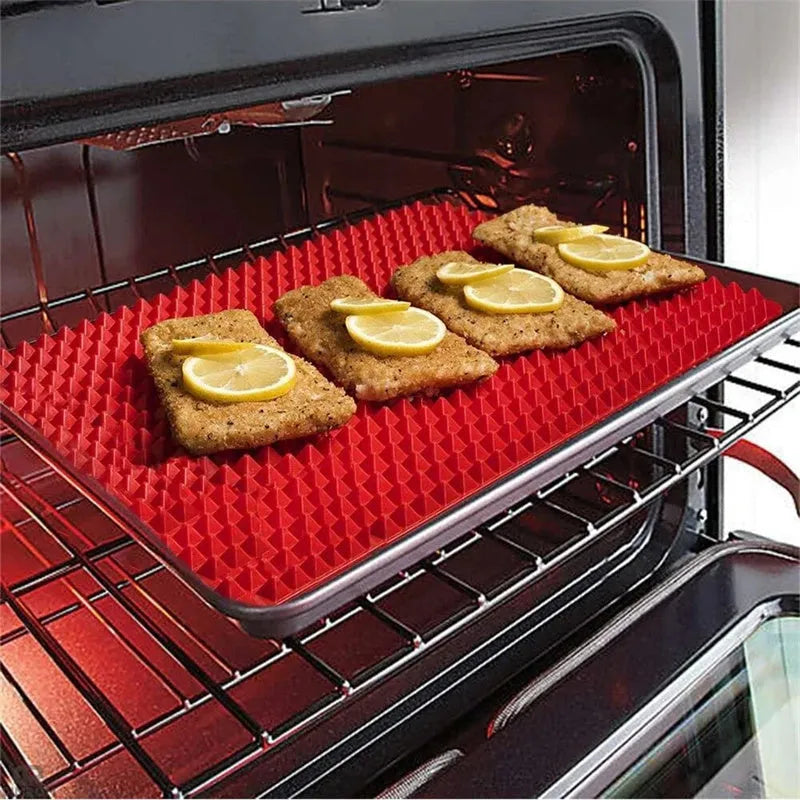 Red non-stick silicone pyramid cooking mat on a baking tray, showing grid pattern and 39.5 cm size