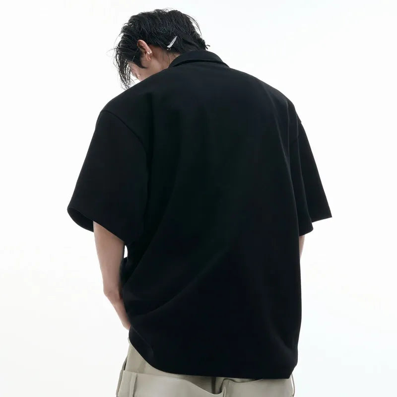 Men's black polo shirt with deconstructed collar and geometric pattern design