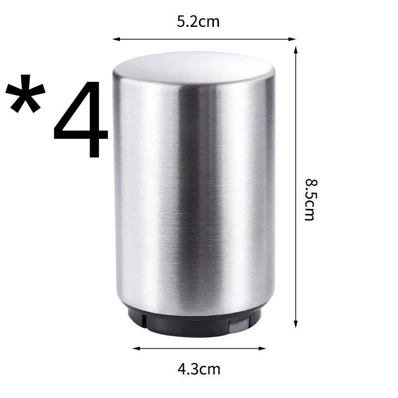 Automatic stainless steel beer bottle opener with magnetic cap catch on a table