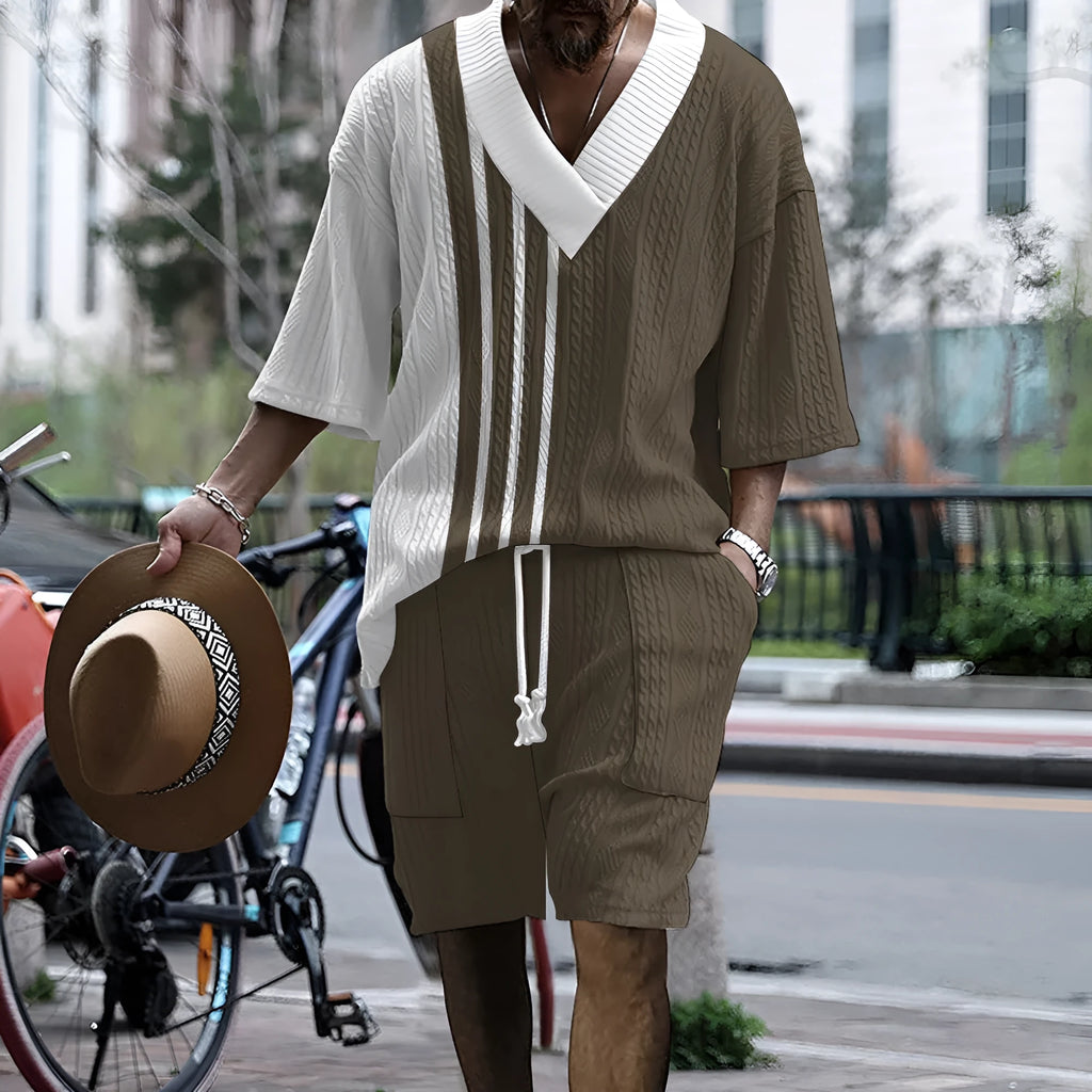 Man wearing a printed drop-shoulder knitted short-sleeved top with matching shorts in a casual setting.