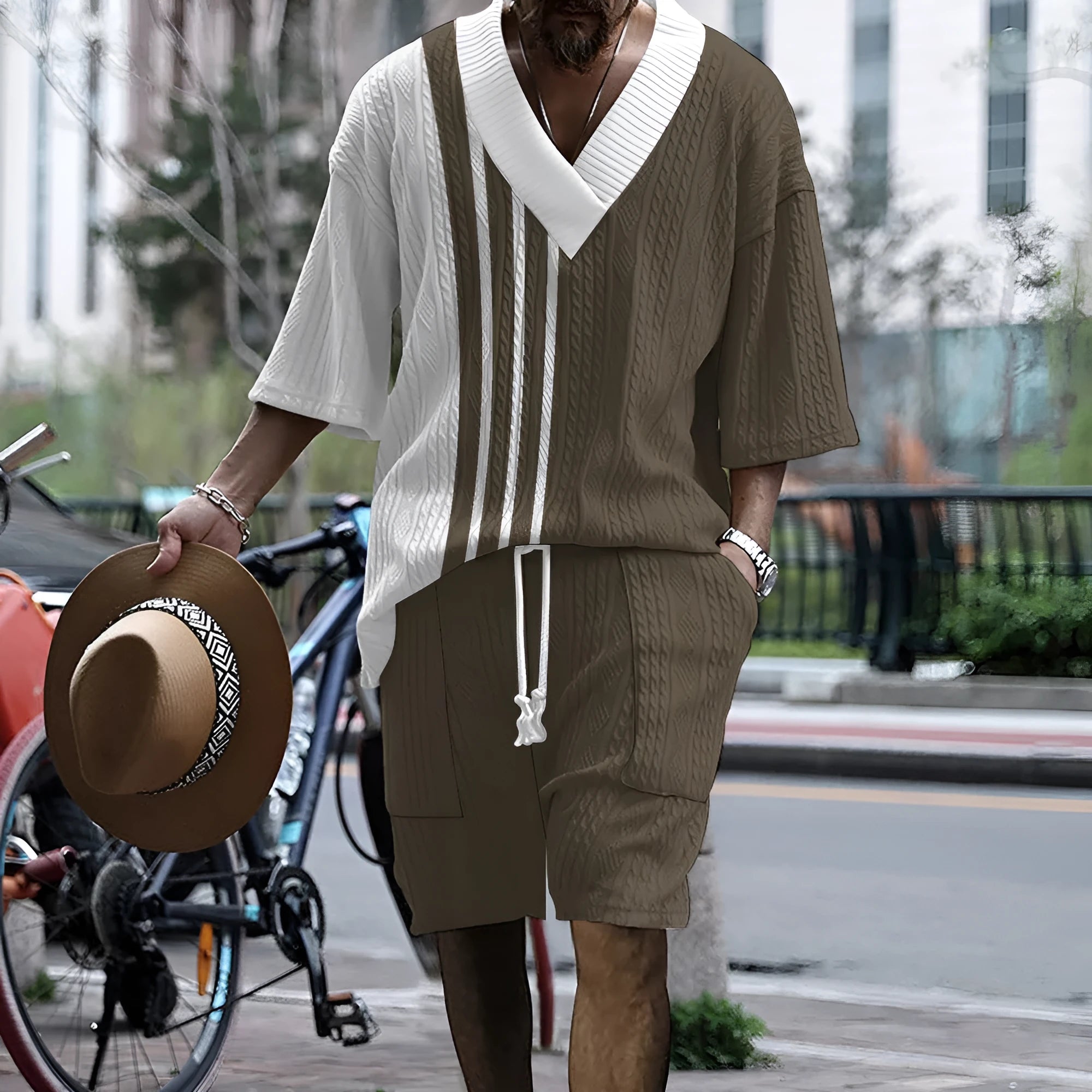 Man wearing a printed drop-shoulder knitted short-sleeved top with matching shorts in a casual setting.