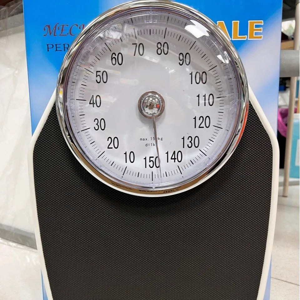 Black mechanical body weight scale with large dial showing weight measurements