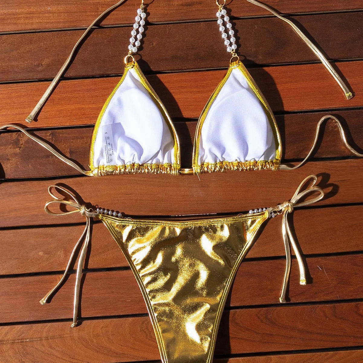 Gold halter lace-up bikini set with pearl chain detail for beach and pool wear