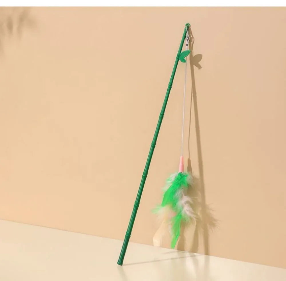 Green interactive cat toy feather wand with bell refills and feathers on a white background