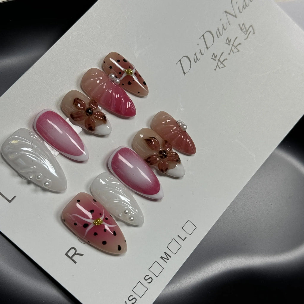 Hand-painted 3D nail patches with embossed candy patterns in almond shape on plastic armour suit