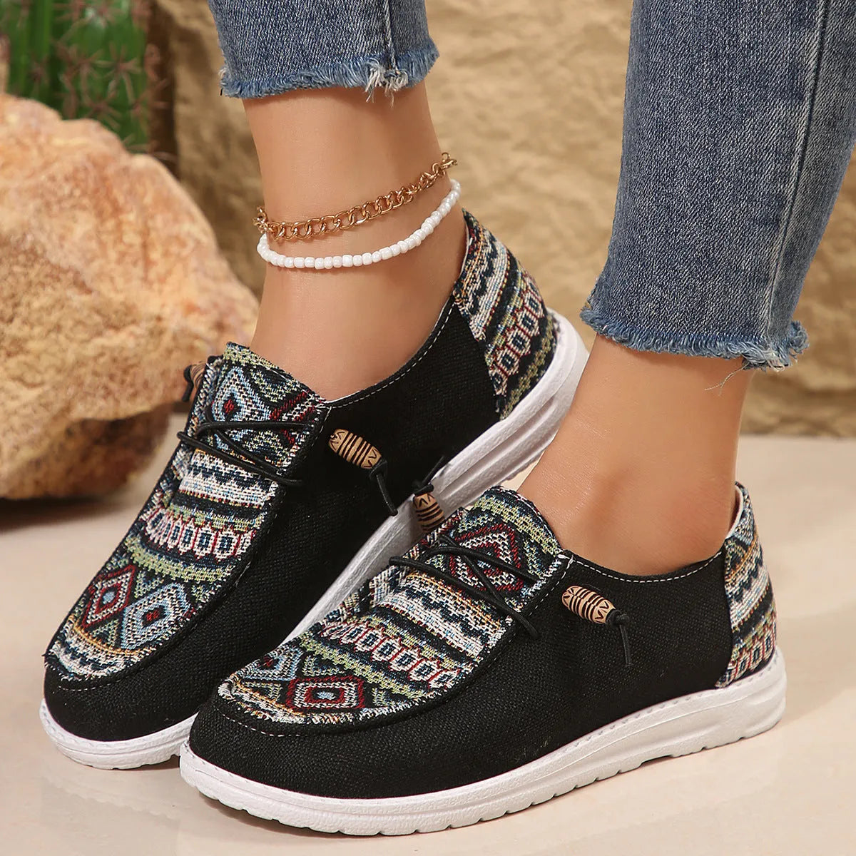 Women's low-top flat shoe in black with round toe and rubber sole, shown as an overshoe cover.