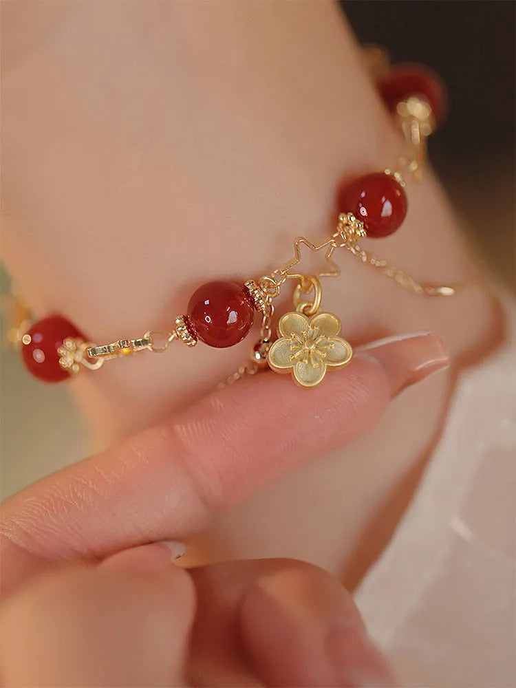 Red agate double layer bracelet with peach blossom decoration on female wrist