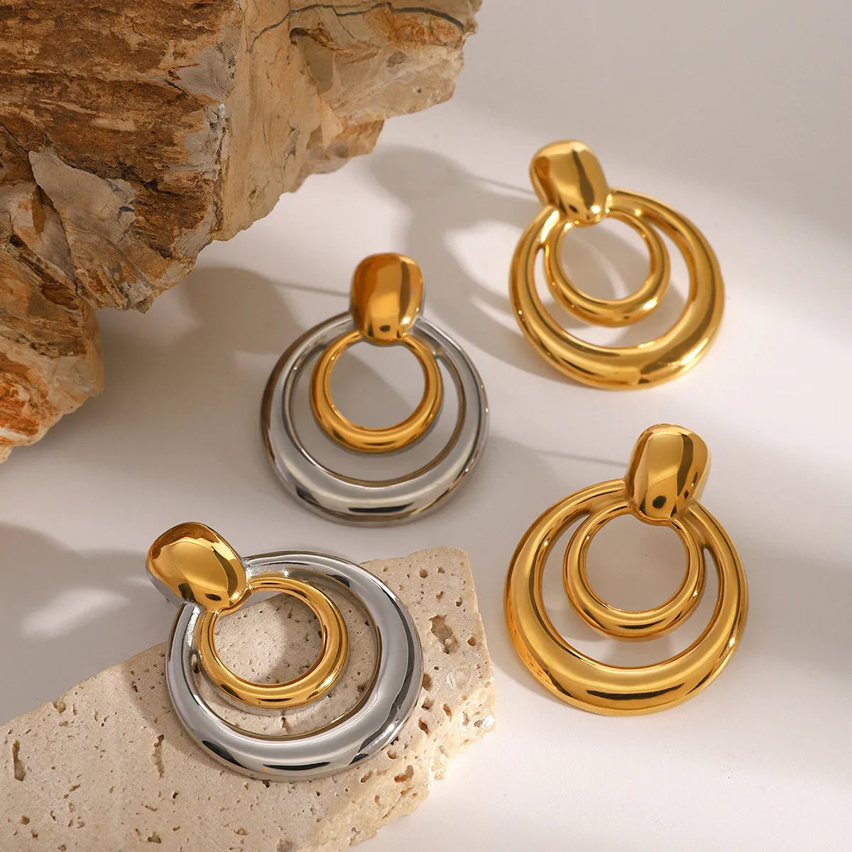 Golden double layer hollow stud earrings with geometric round shape and 18K gold electroplated finish