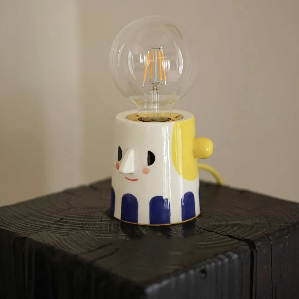 Handmade ceramic bedside lamp with ball headlight design in warm white colour