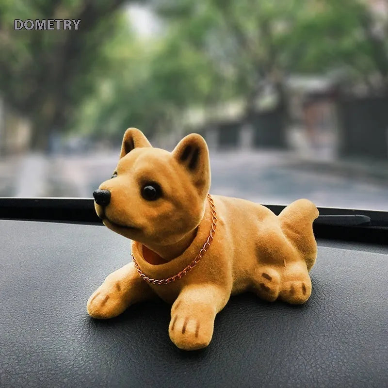 Resin head-shaking dog car decoration in multiple breed colour options on a car dashboard