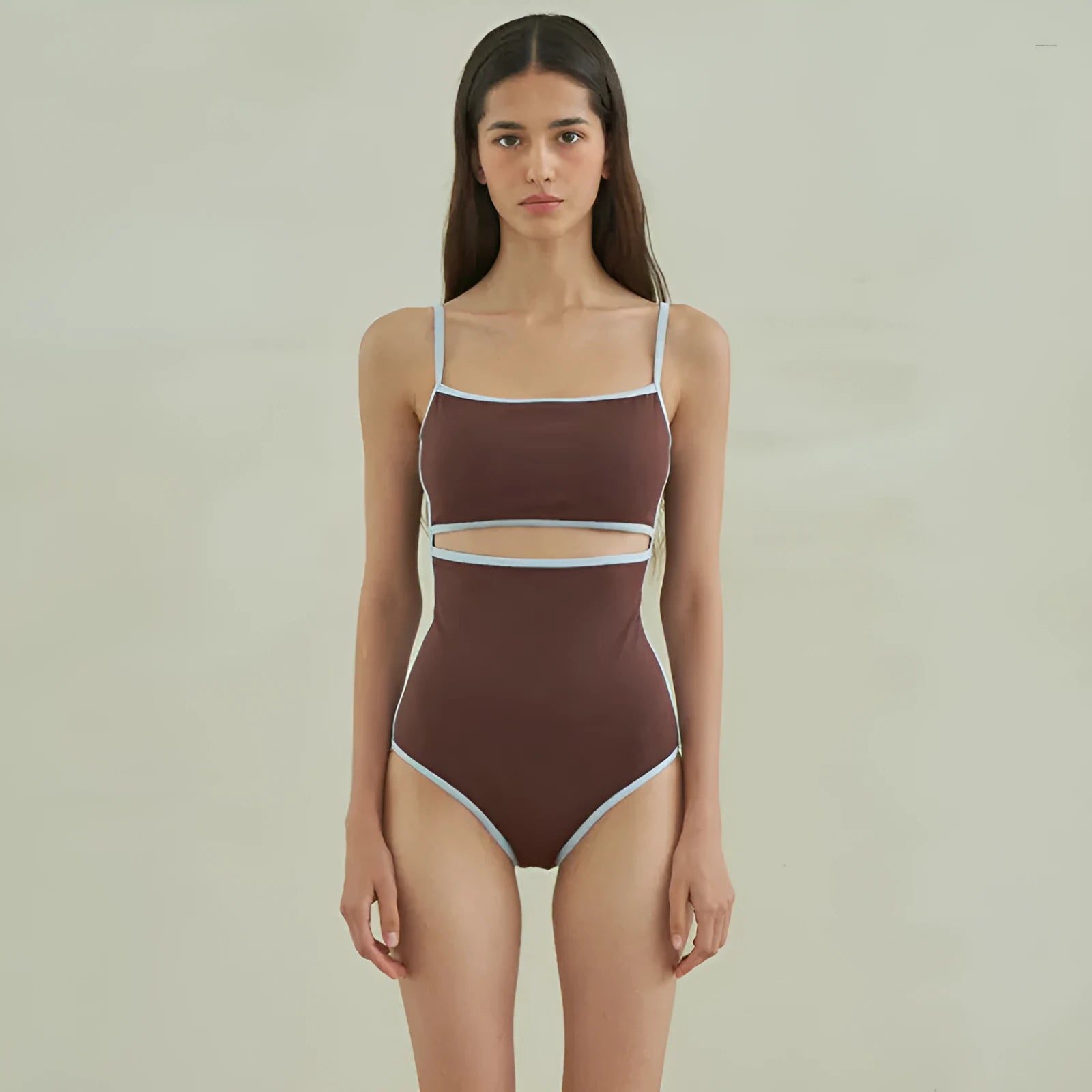 Brown women's one-piece triangle swimsuit on a hanger, showing front design.
