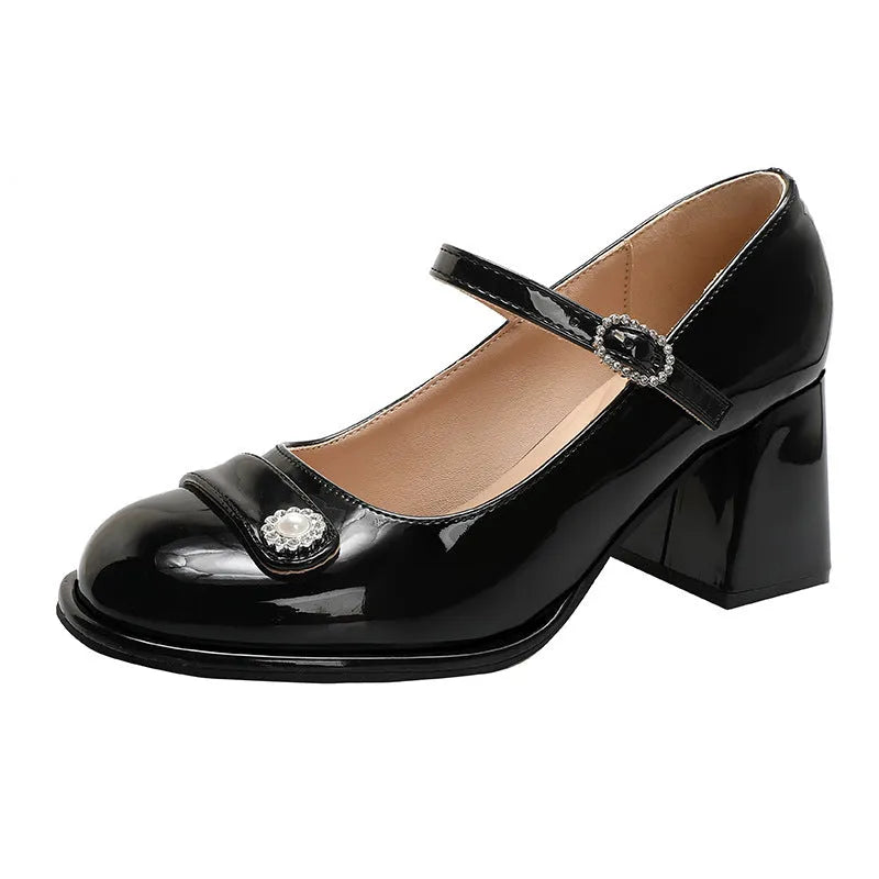 Women's black patent leather wide fit high heels with a round toe and chunky heel.