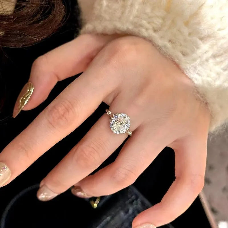 Silver geometric ellipse women's ring with adjustable opening on a white background.