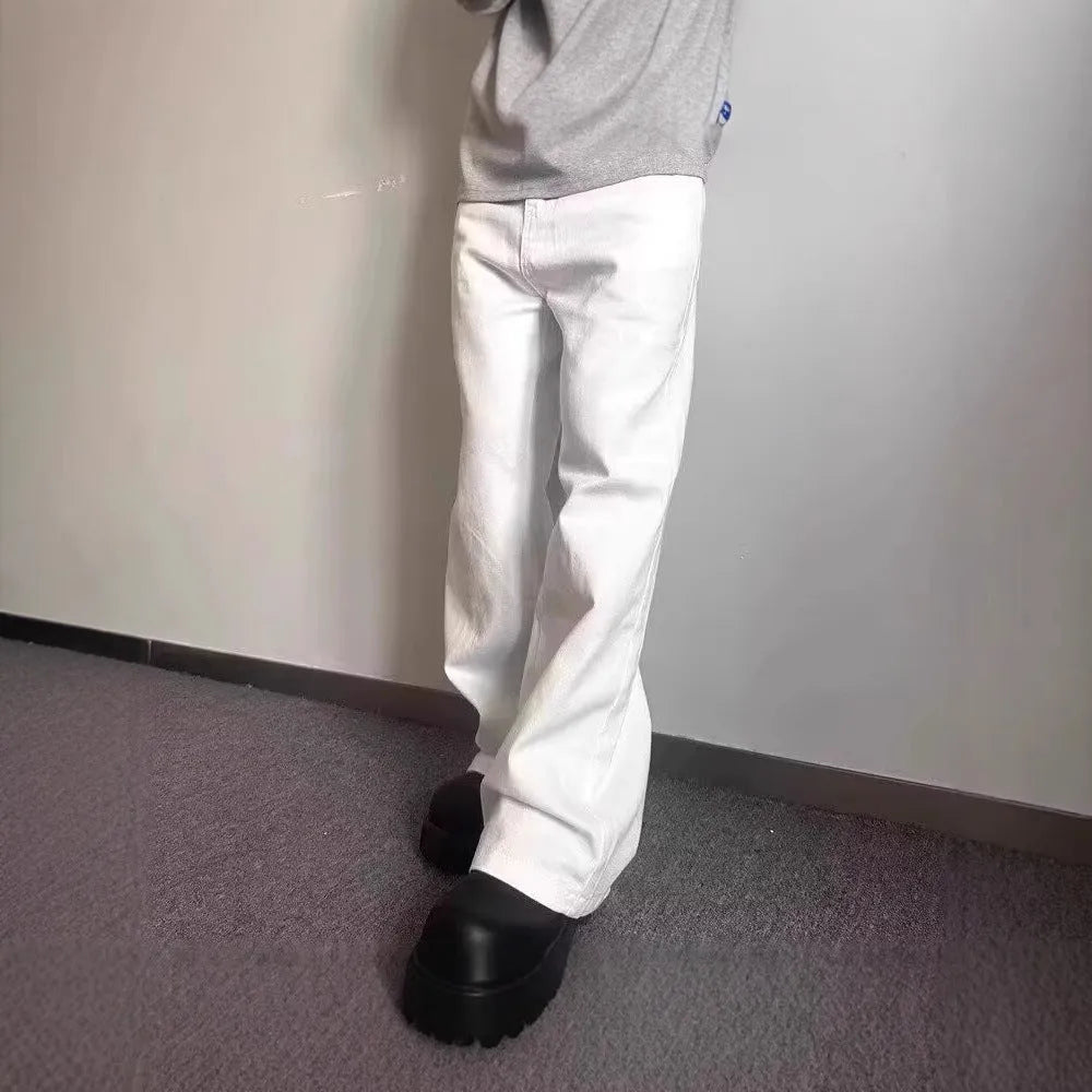 Men's white loose fit straight-leg cotton denim jeans on a plain background.