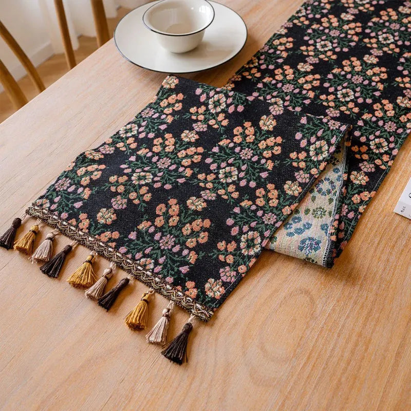 Nordic jacquard bouquet pattern table runner with tassels in dark blue on wooden table