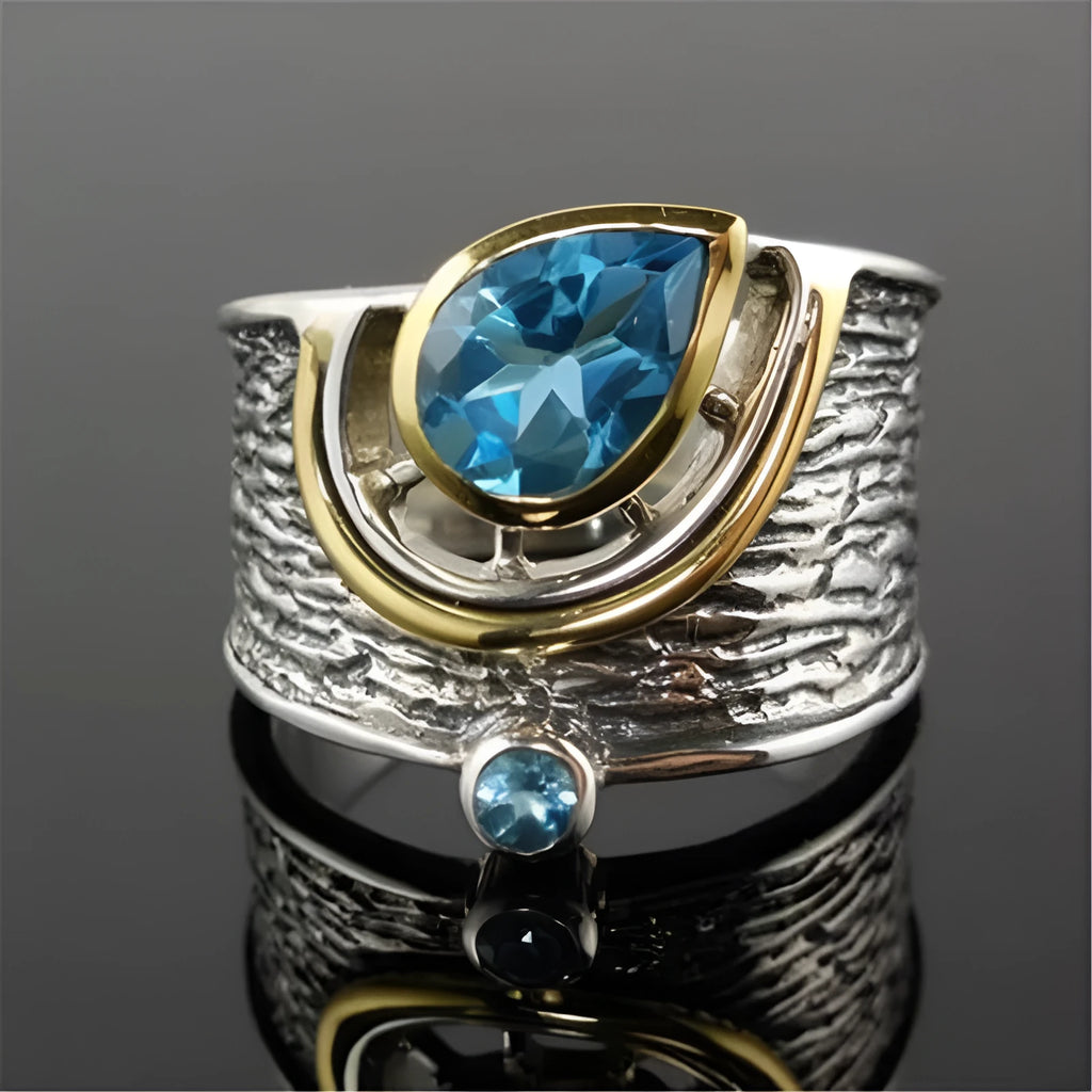 Close-up of a blue drop-shaped zircon rhinestone set in a creative Chinese style alloy women's ring.
