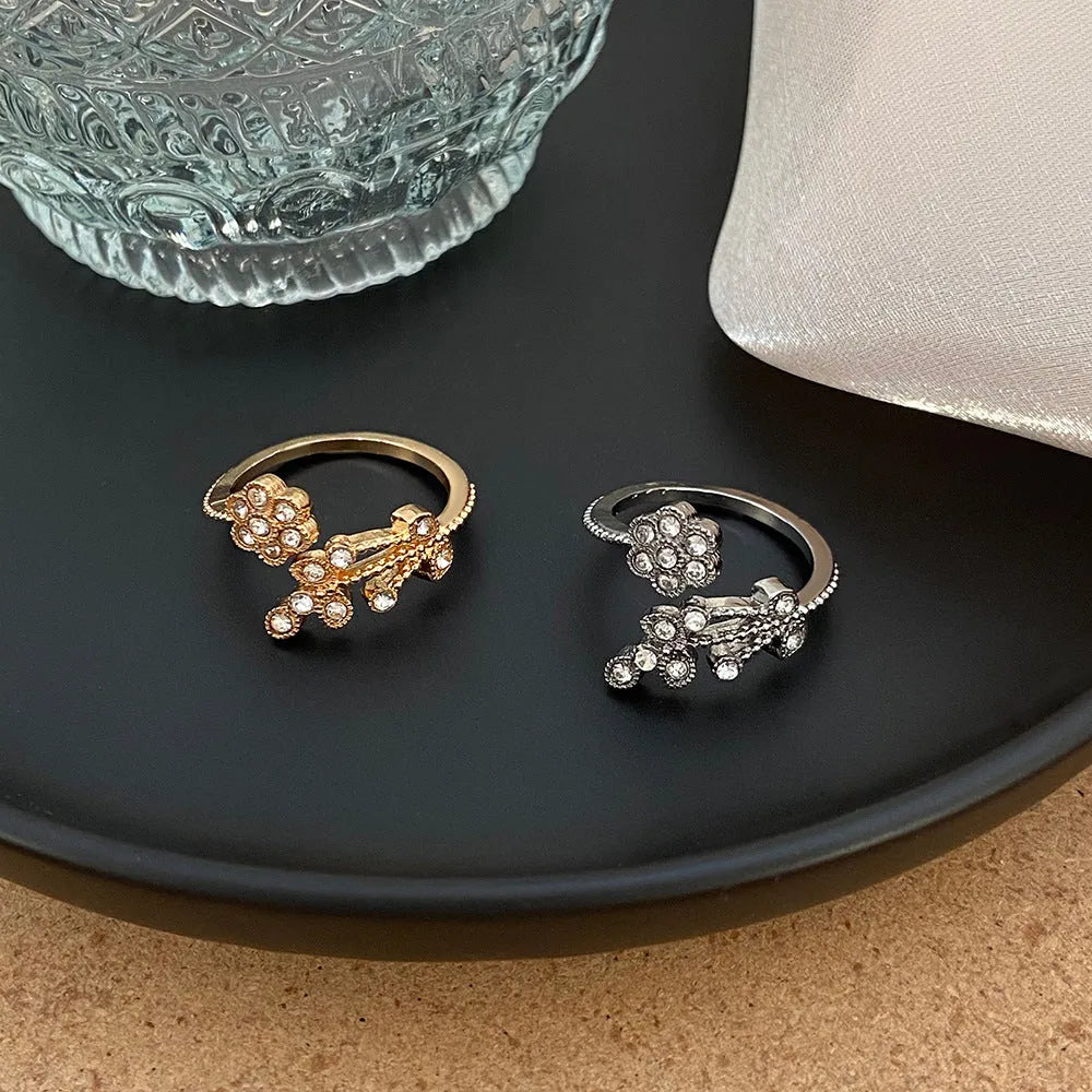 Open mouth copper ring with flower and leaf design in gold finish
