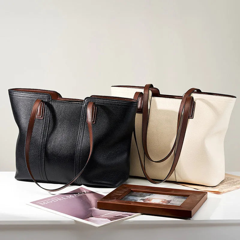 Women's black genuine leather crossbody commuter bag with horizontal square design showing internal organisation compartments