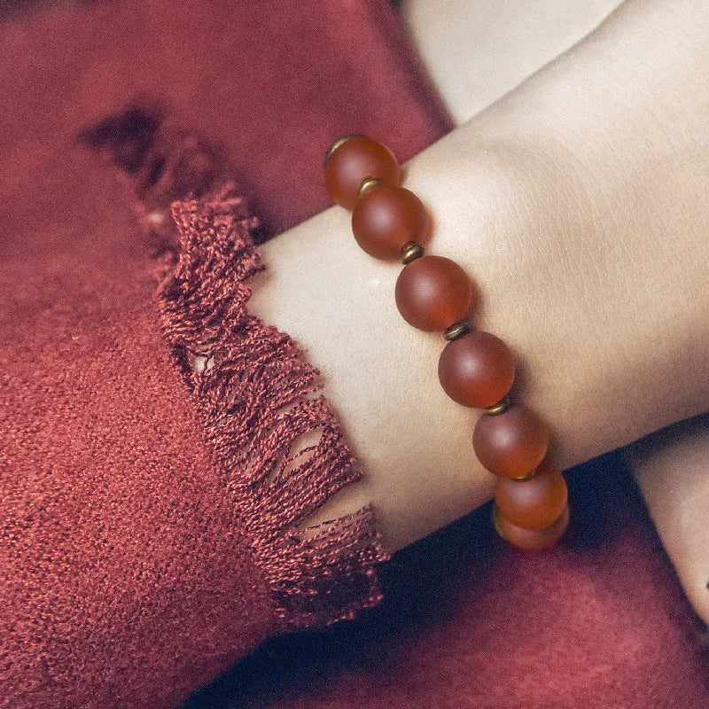 Retro ethnic style natural crystal and agate beaded couples bracelet in red agate on neutral background