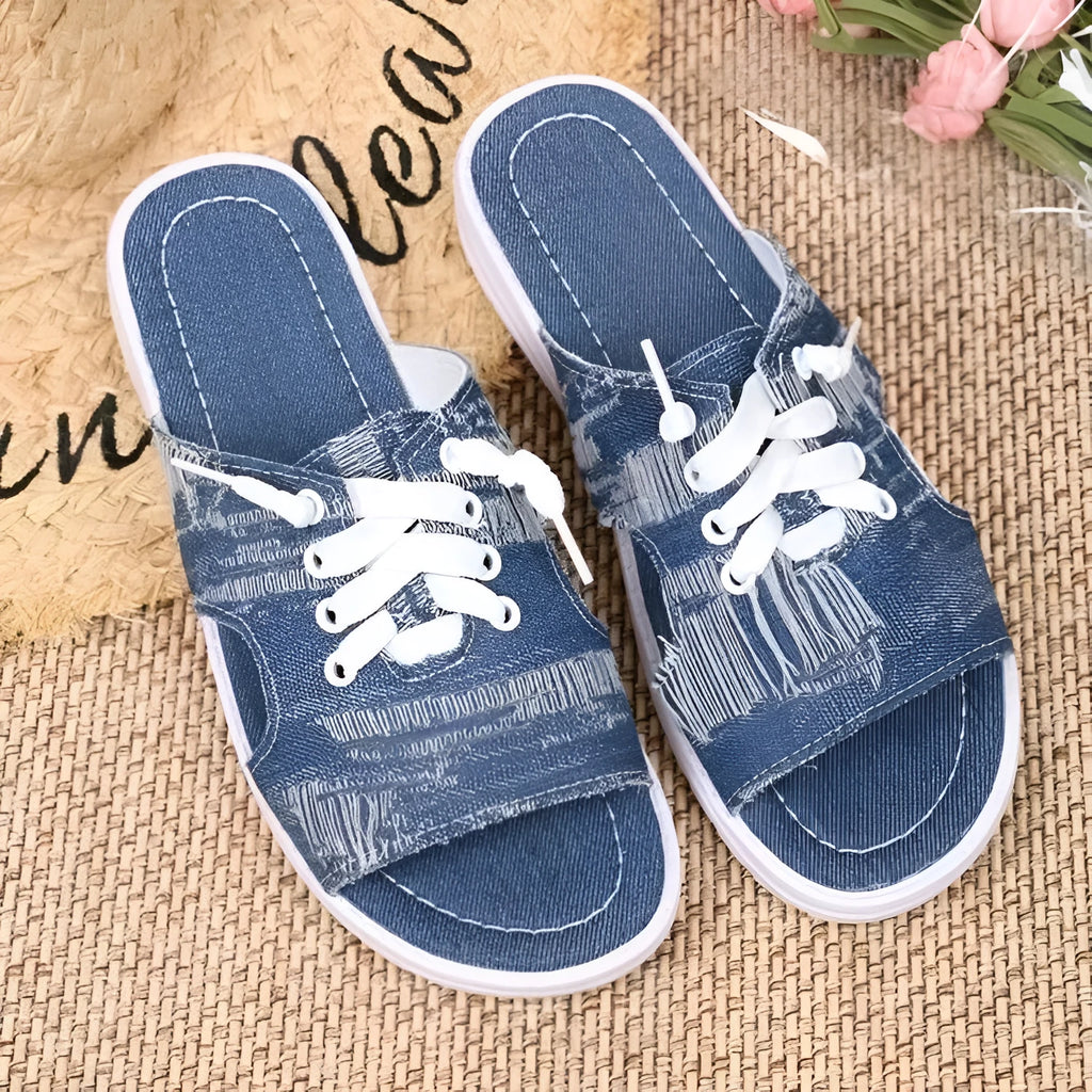 Blue women's canvas slippers in Roman style with a flat design and rubber sole