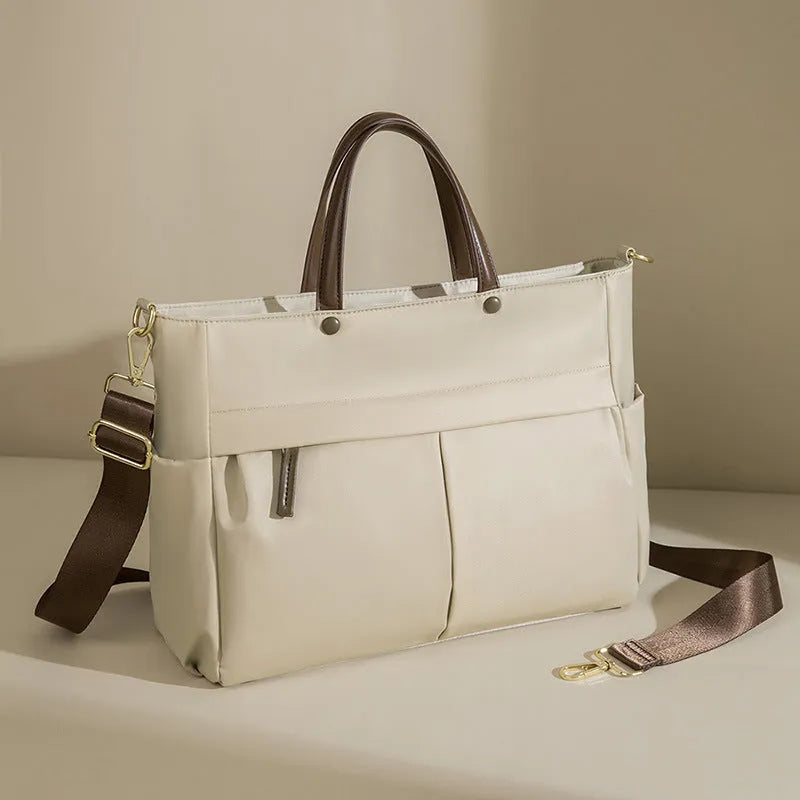 Women's Oxford cloth laptop briefcase showing elegant black colour with multiple open pockets and portable handle