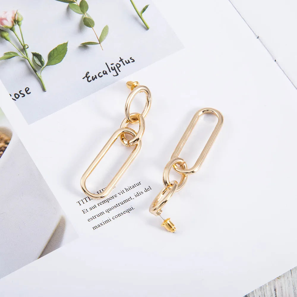 Geometric sterling silver needle coloured hoop earrings for women showing ring and line design elements.