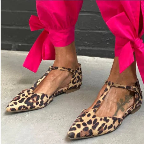 Women's leopard print pumps with pointed toe, chunky low heel, and cross shoulder straps