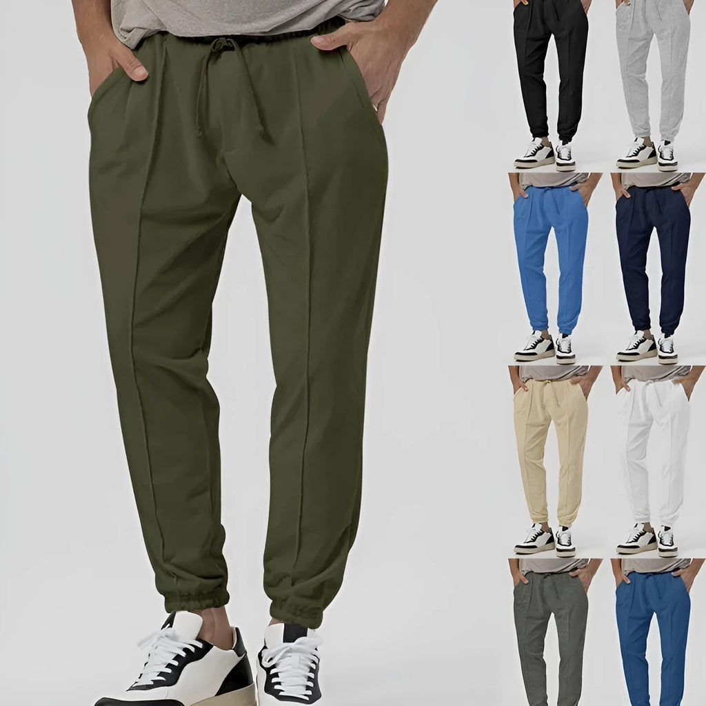 Men's gray loose fit tapered casual sweatpants with elastic waistband on a neutral background.