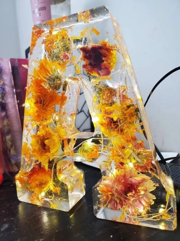Letter flower transparent resin night light ornament with 15cm dimensions on a table