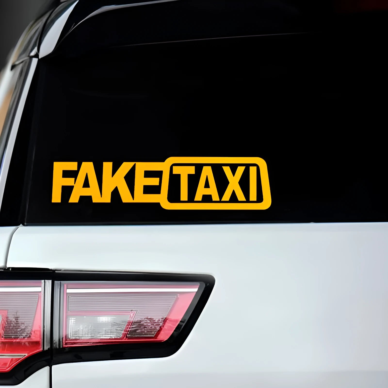 Black waterproof PET car sticker with white FAKE TAXI text, measuring 20 cm by 8 cm.