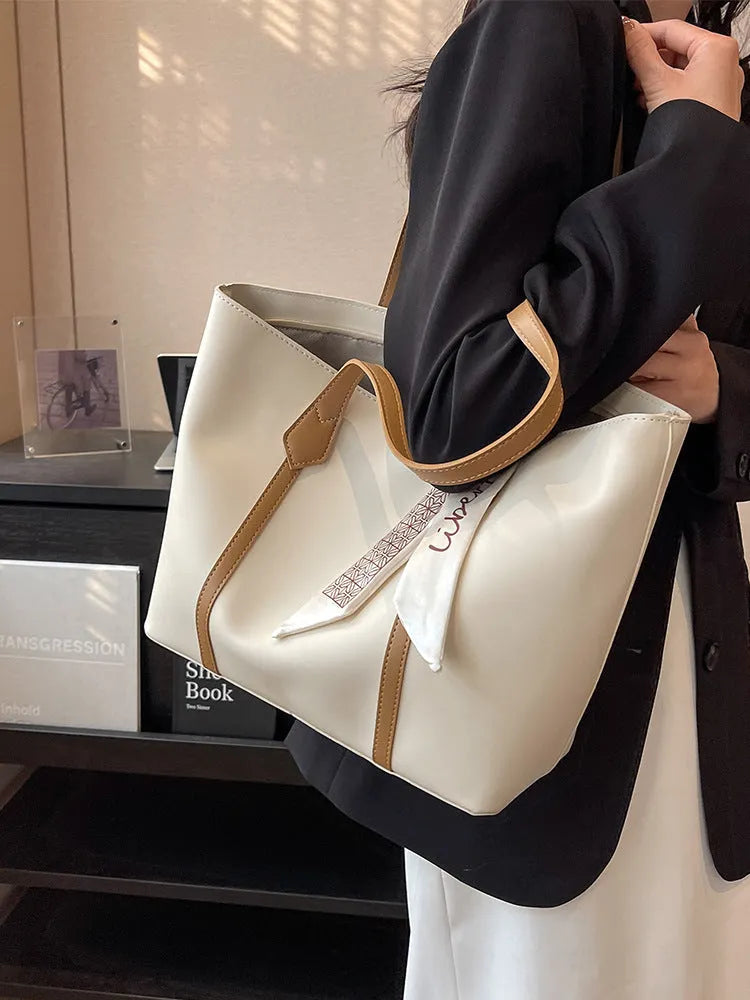 Women's large capacity soft tote bag in multiple colour options showing bucket design and crossbody strap