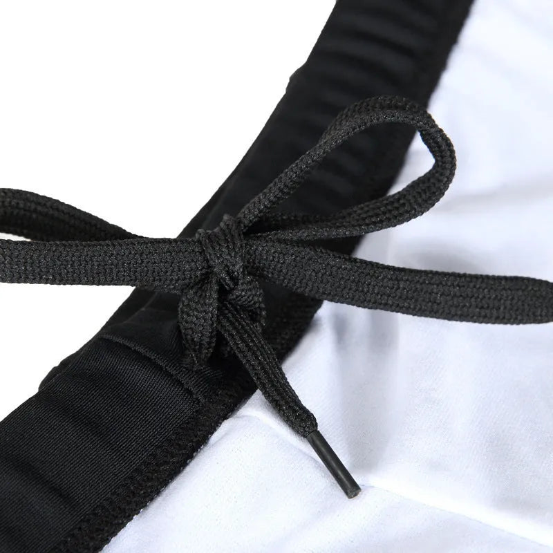 Men's plus size blue fire pattern boxer swimming trunks on a black background.