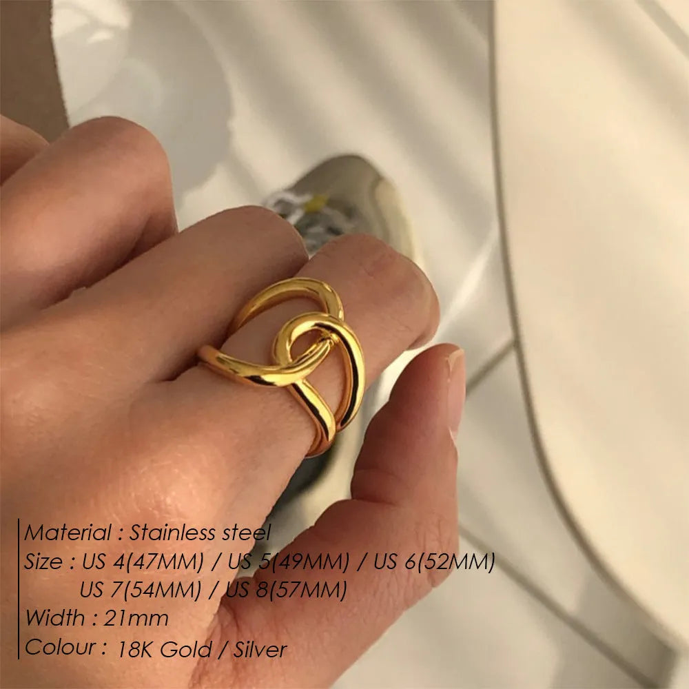 Adjustable knotted stainless steel ring in geometric U-shape, shown in gold and steel colours.