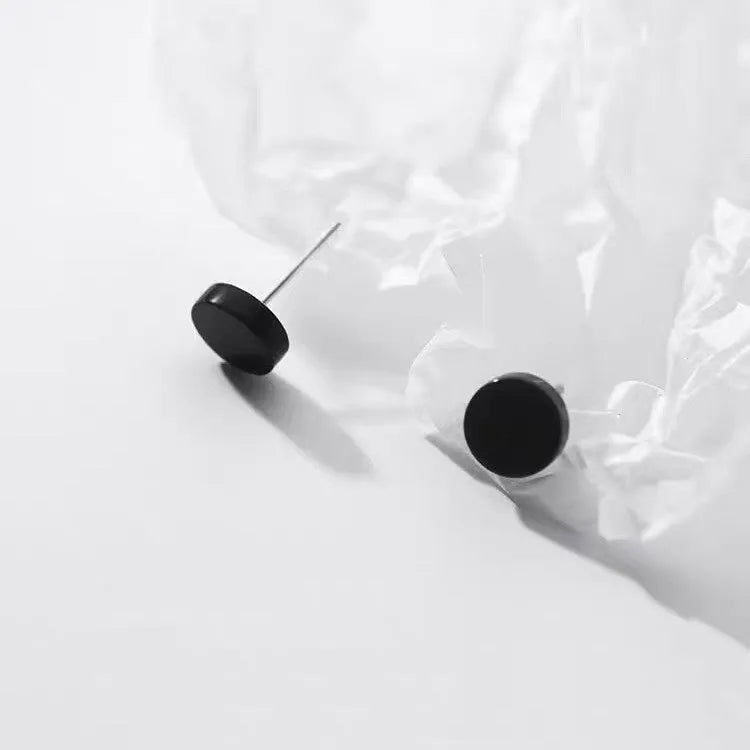 A pair of simple round flat S999 Sterling Silver ear bone studs for cartilage piercing.