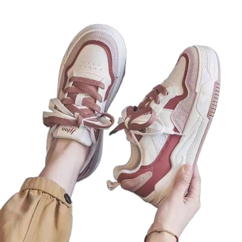 Women's pink low top sneaker with a rubber platform sole on a white background.