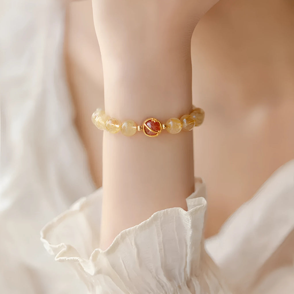 Natural citrine gold rutilated quartz diamond cut bracelet 6mm beads on neutral background