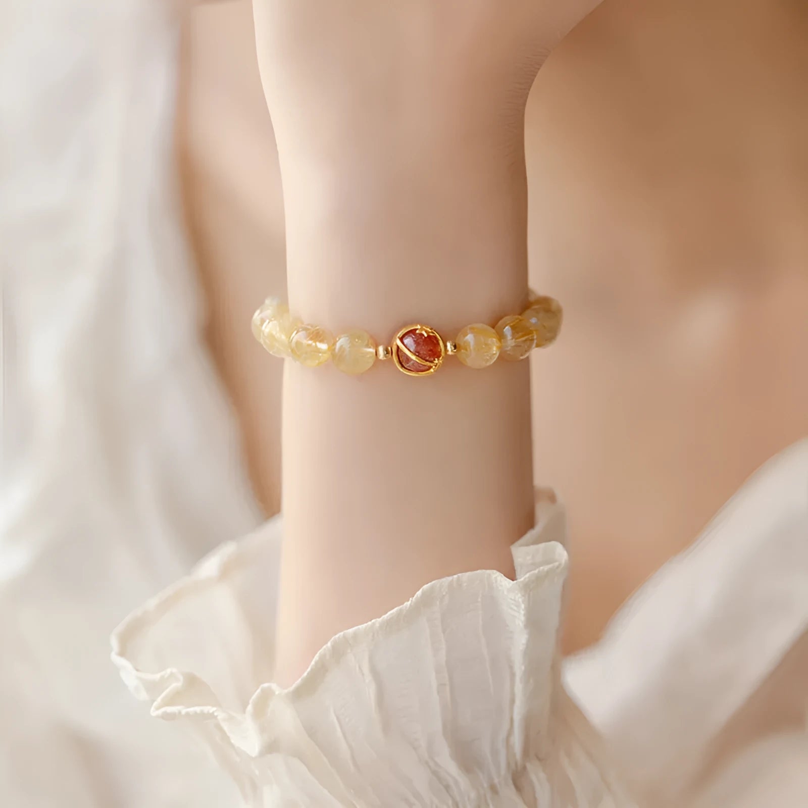 Natural citrine gold rutilated quartz diamond cut bracelet 6mm beads on neutral background
