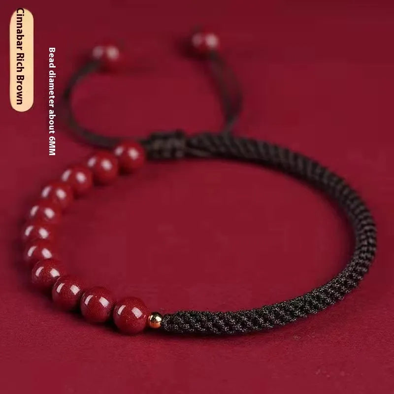 Braided rope bracelet with cinnabar beads in 8mm diameter and wine red colour