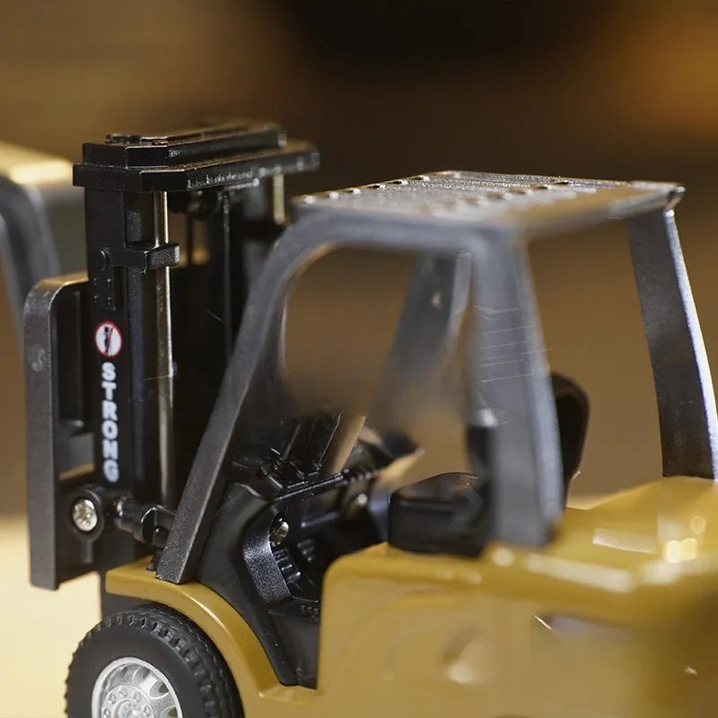 Alloy remote control engineering vehicle set with dump truck, excavator, and small forklift on a table