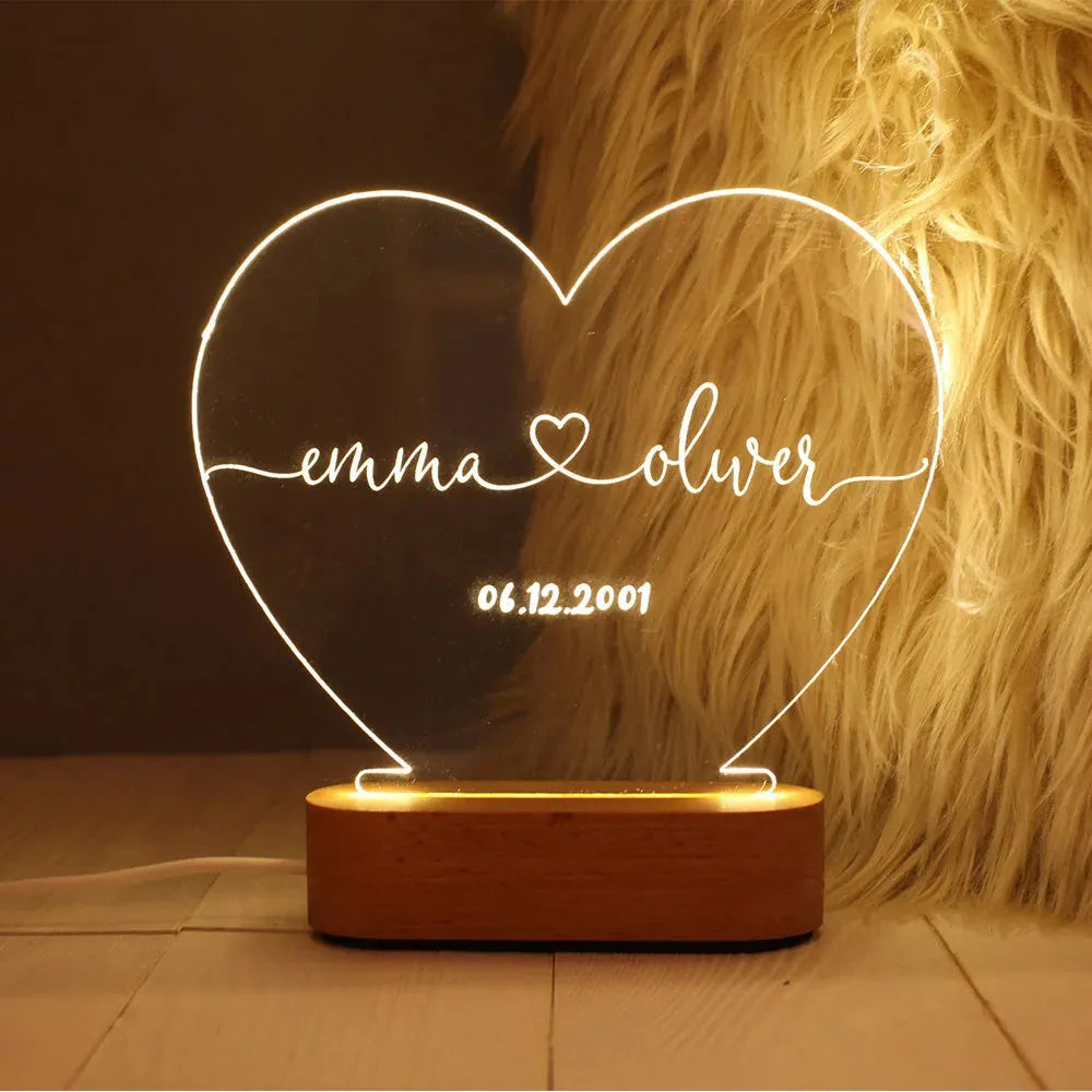 Custom acrylic LED night light displaying engraved names and dates on clear 20cm by 11.5cm panel
