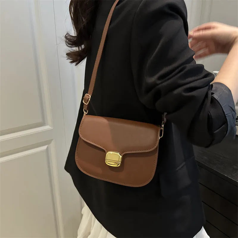 Simple PU leather handbag for women with zipper closure, available in multiple colours including black, brown, and green