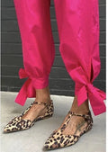 Women's leopard print pumps with pointed toe, chunky low heel, and cross shoulder straps