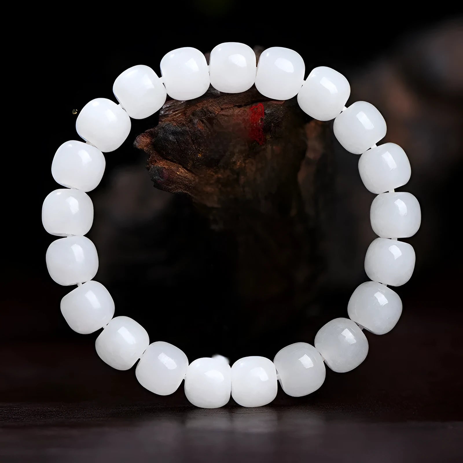 White Hetian jade barrel bead bracelet on a wrist, showing the unisex casual design.