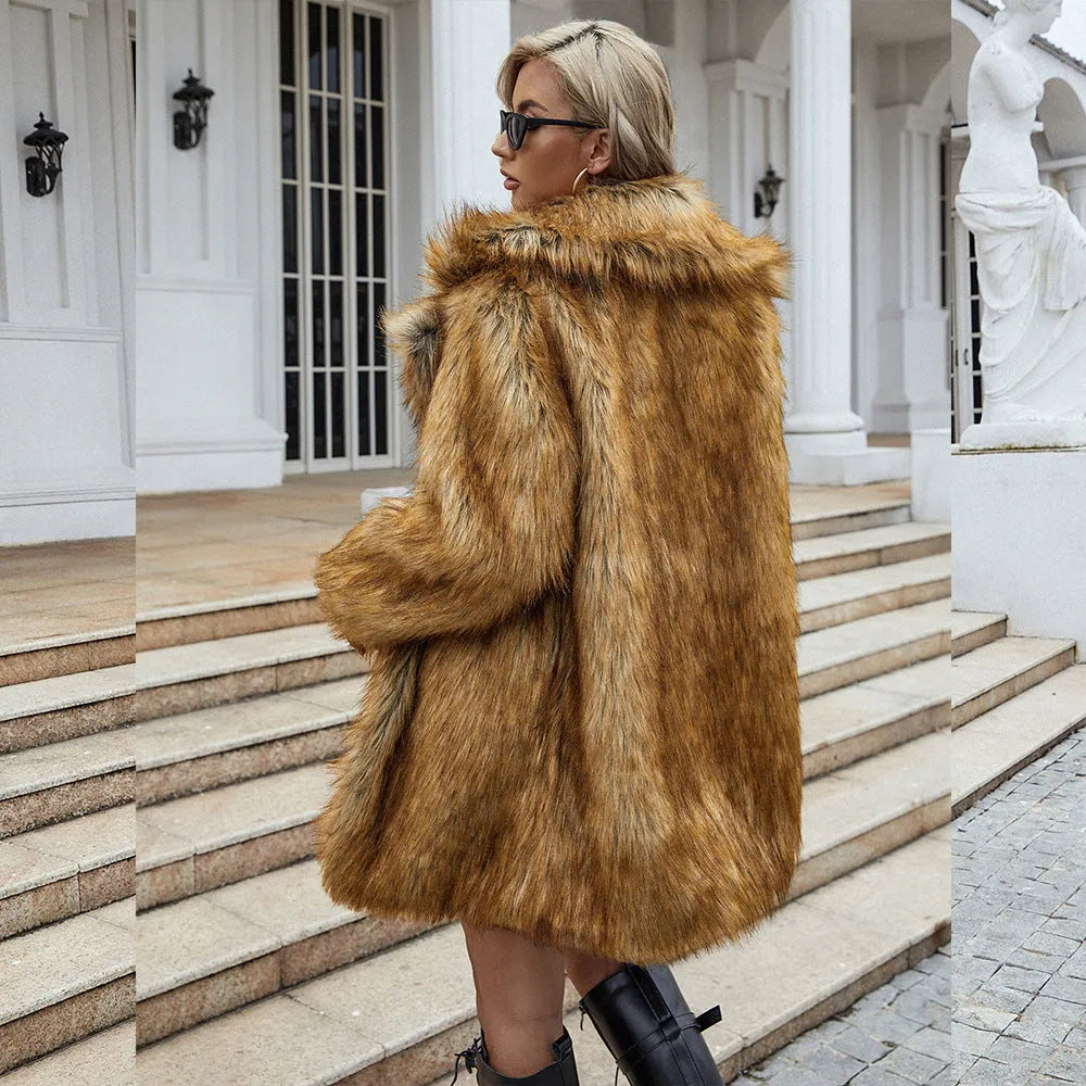 Yellow loose women's artificial fur coat with regular sleeves on a hanger