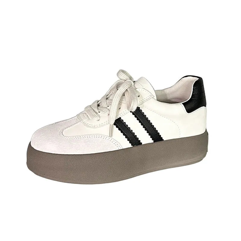 Women's beige vintage distressed leather low-top lace-up sneakers with round toe on a plain background.