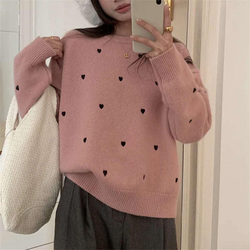 Women's loose-fit acrylic pullover sweater with embroidered love pattern in milky white.