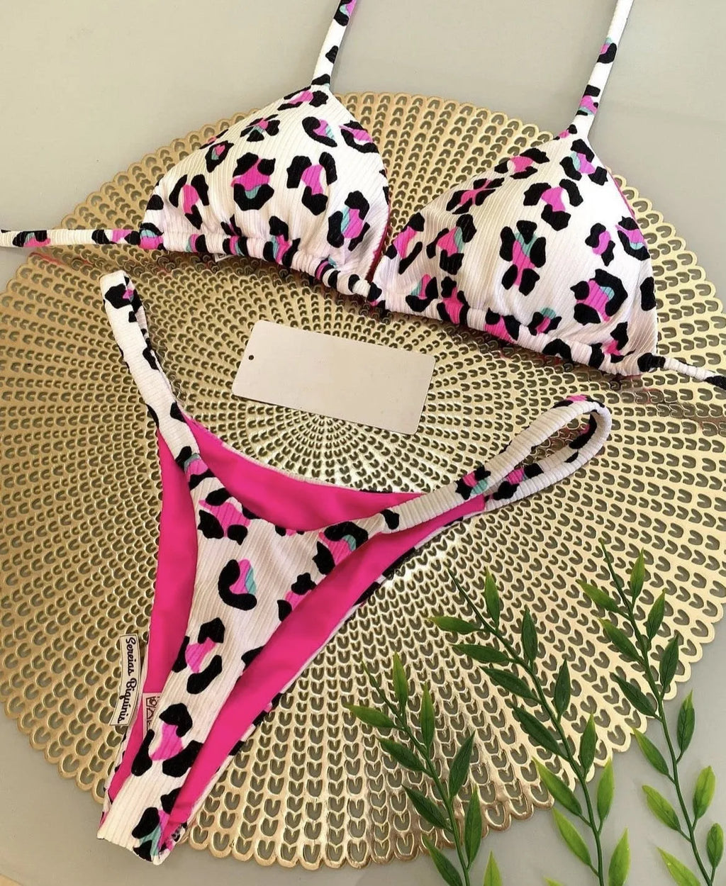 Women's printed bikini swimsuit set with quick-dry fabric on a mannequin, showing briefs style.