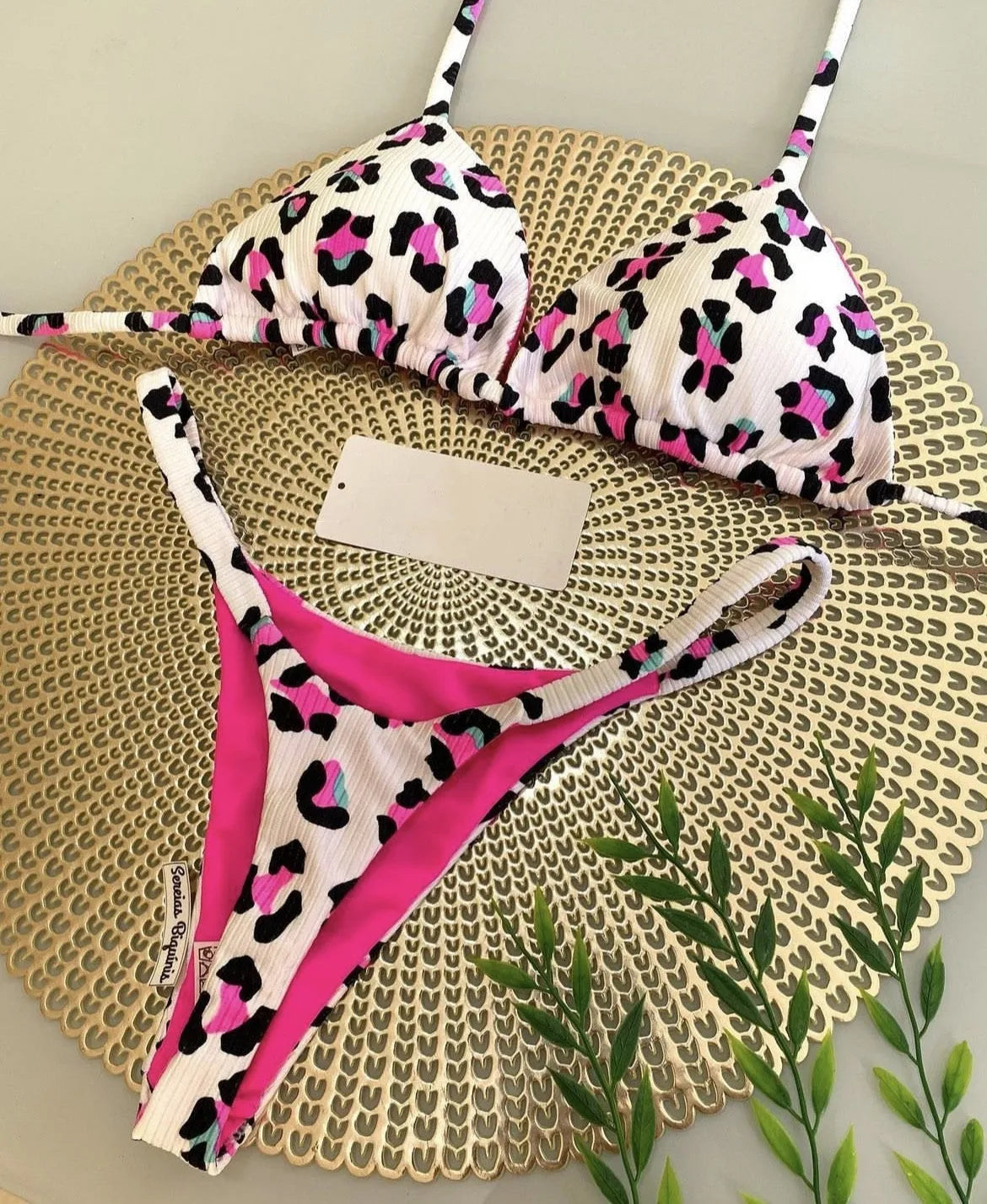Women's printed bikini swimsuit set with quick-dry fabric on a mannequin, showing briefs style.