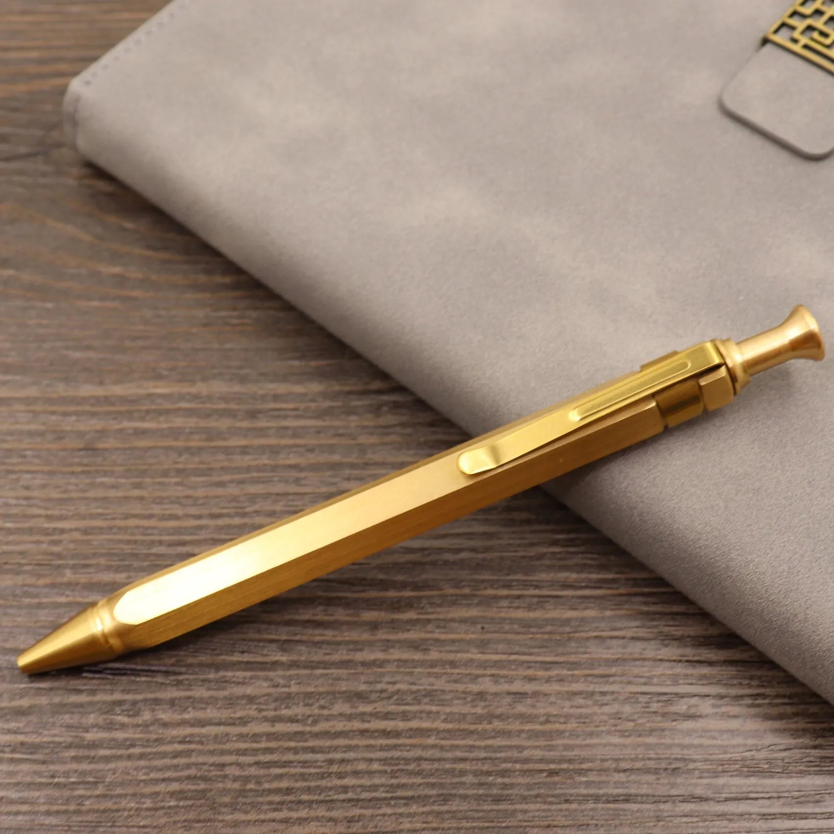 Retro brass tactical pen with bolt-action press mechanism and brushed finish.
