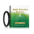 Men's black gallstone and glass bead smoke prevention bracelet on a wrist.